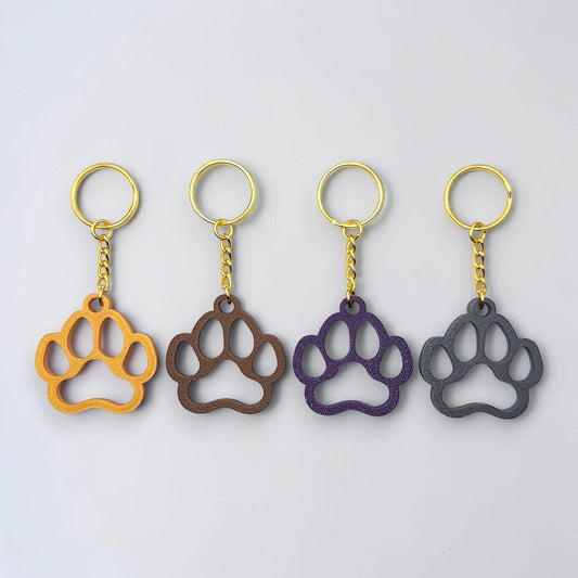 Handmade and customizable paw keychains with gold colored keyrings, ideal for honoring pets, gifting to animal lovers, or everyday use.