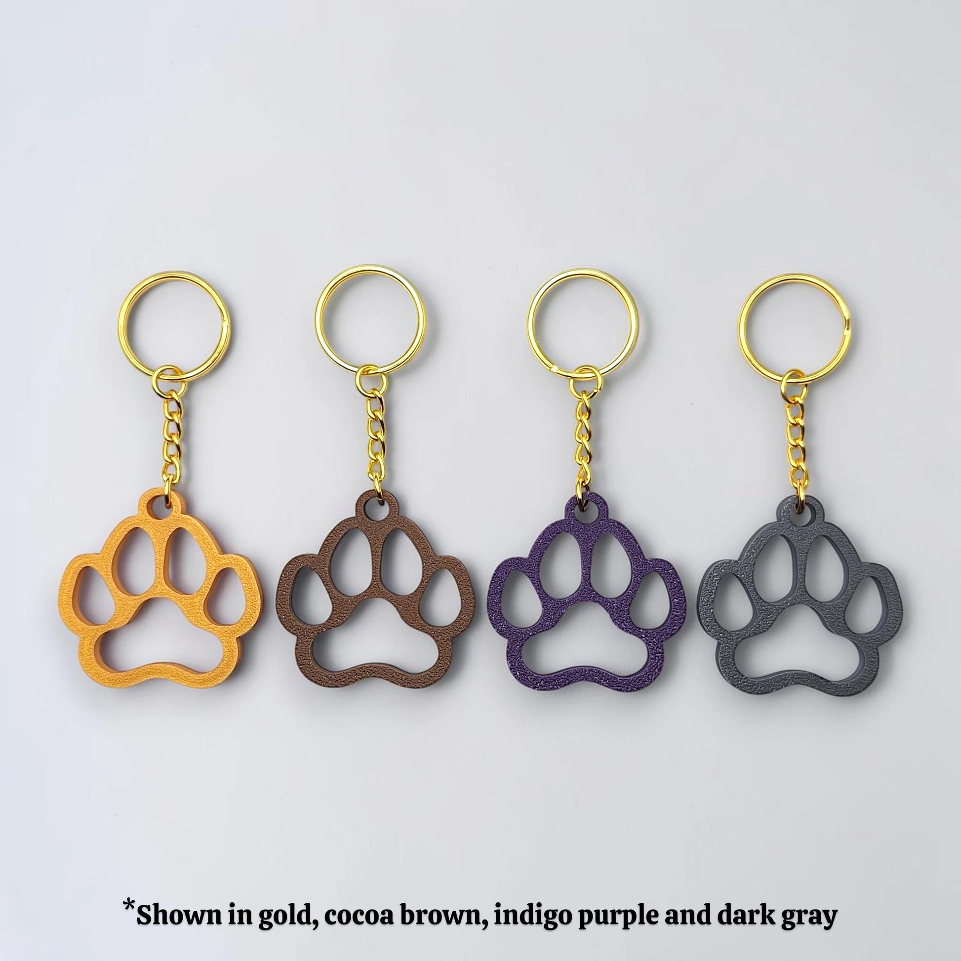 Handmade and customizable paw keychains in various colors, ideal for honoring pets, gifting to animal lovers, or everyday use.