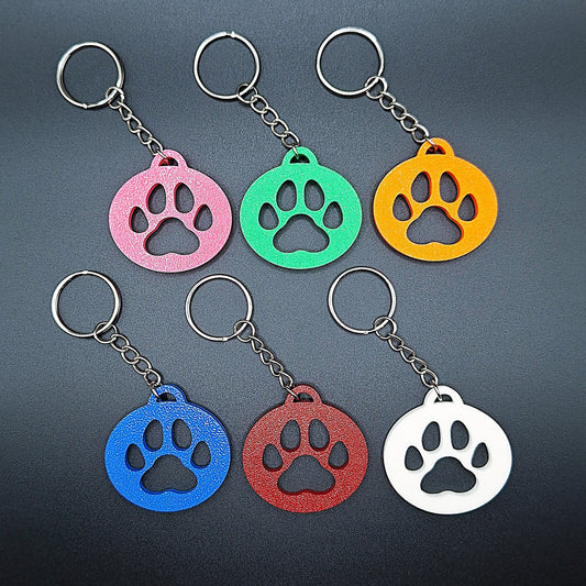 Front view of six minimalist paw print keychains in assorted vibrant colors, made from eco-friendly PLA, perfect for pet lovers and gifts.