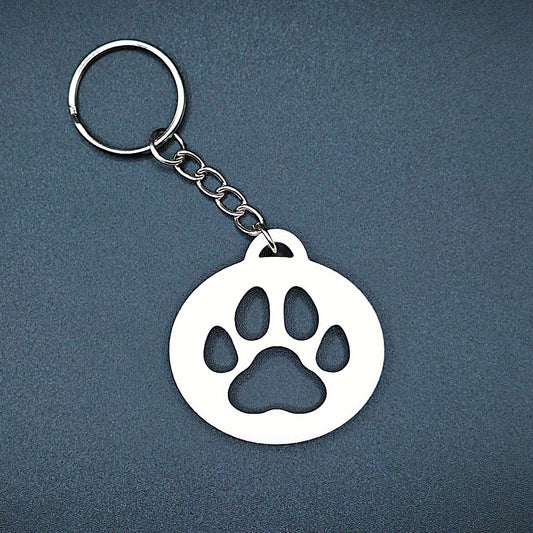 White minimalist paw keychain handmade from compostable PLA plastic, ideal for dog moms, cat lovers, or pet loss remembrance tokens.