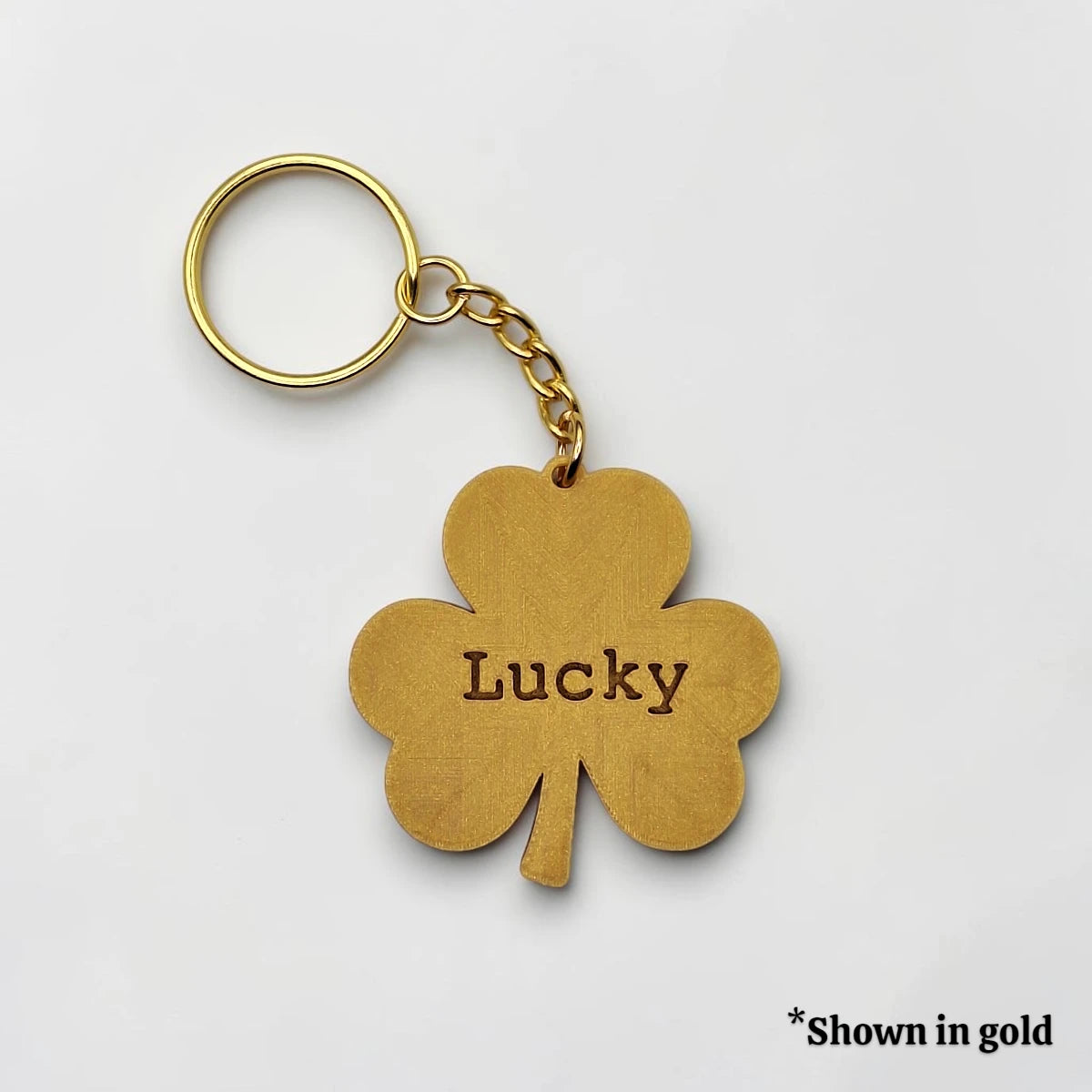 Personalized and engraved Shamrock keychain in gold showing a classic three leaf clover shape, perfect for Irish gifts, St. Patrick's Day events, giveaways and family reunions.