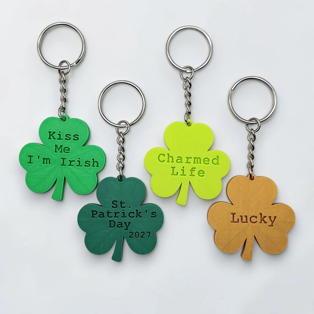 Personalized and engraved Shamrock charms showing a three leaf clover shape, perfect for Irish gifts, St. Patrick's Day events, giveaways and family reunions.