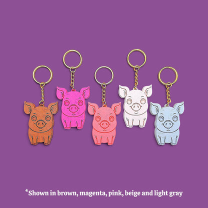 Handmade and customizable pig keychains in five colors with gold keyrings, ideal for country themed party favors, cute farm animal bag charms, and classroom prizes.