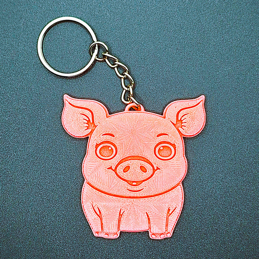 Front view of cute pig keychain featuring charming facial details; eco-friendly farm animal accessory for backpacks, key rings, and gifts.