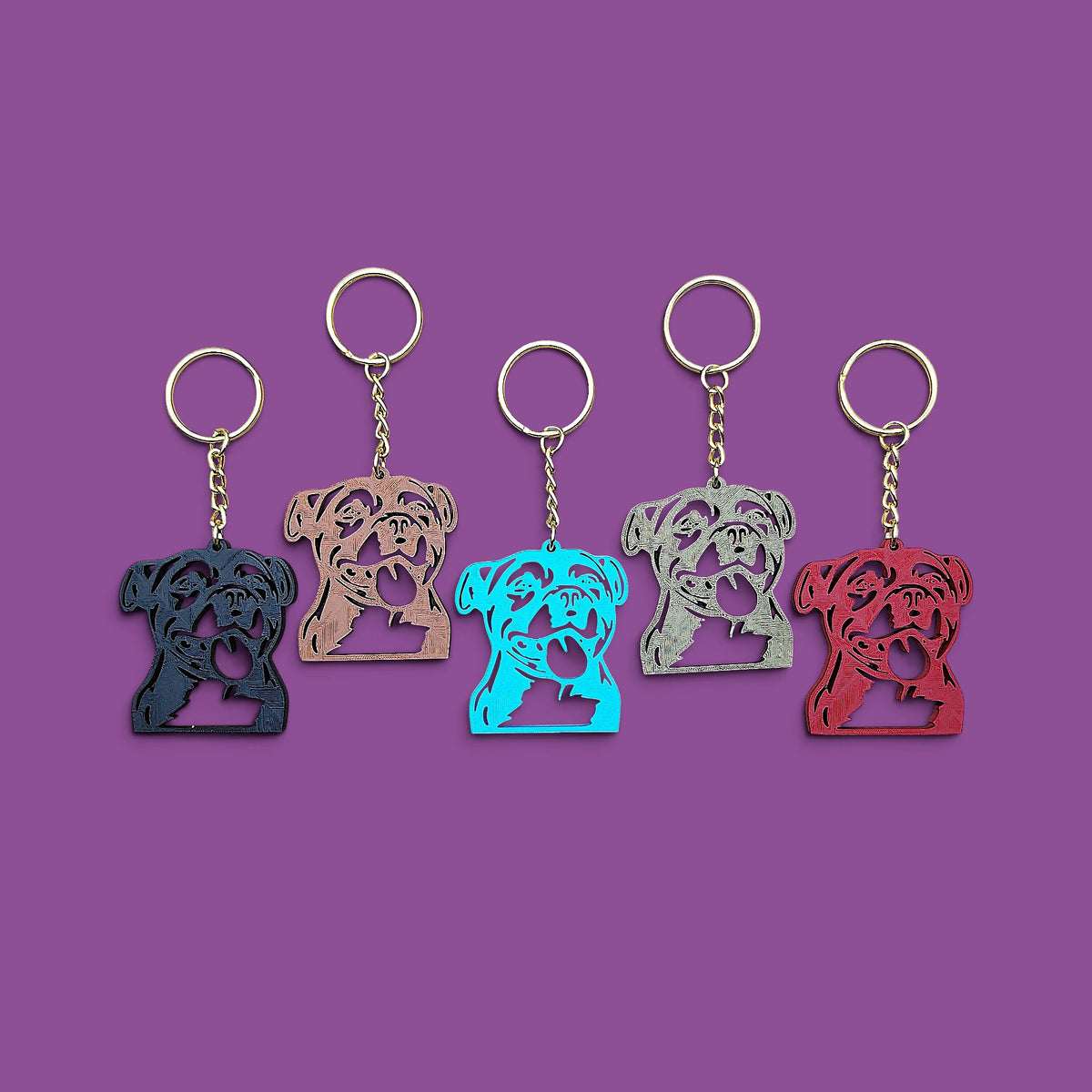 Handmade and customizable pit bull keychains in multiple colors with silver keyrings, perfect for pittie owners, pitbull lovers, party favors, and unique bag charms