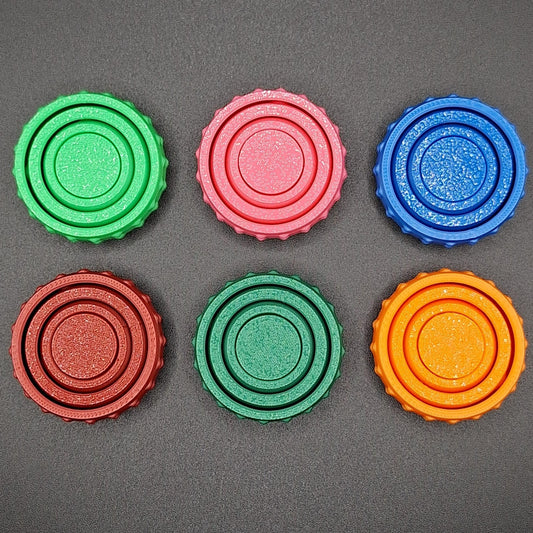 Top view of six colorful pocket fidget spinners, great for anxiety, sensory needs, and focus on the go—compact and eco-conscious design.