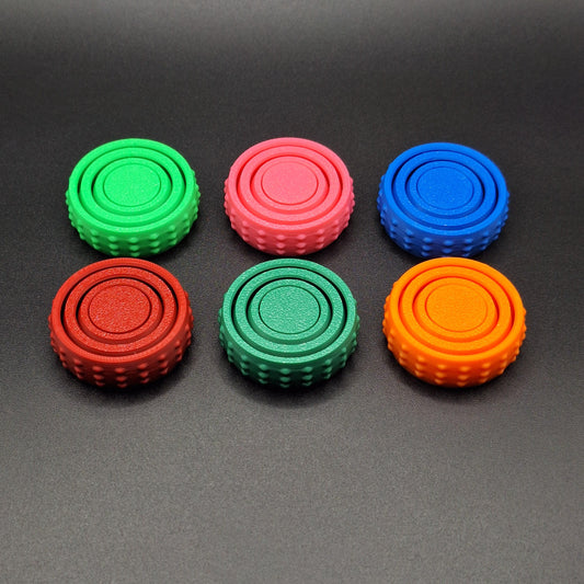 Top view of six colorful pocket fidget spinners, great for anxiety, sensory needs, and focus on the go—compact and eco-conscious design.