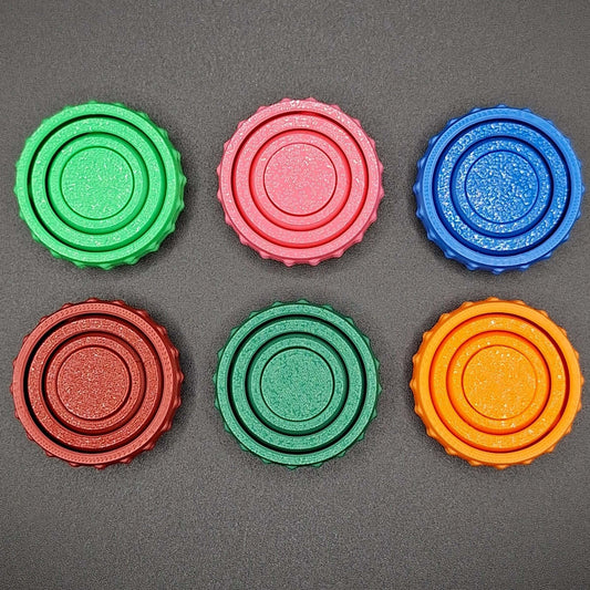 Top view of six colorful pocket fidget spinners, great for anxiety, sensory needs, and focus on the go—compact and eco-conscious design.