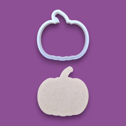 Customizable pumpkin cookie cutter along with a pumpkin dough cutout, perfect for fall, Halloween, and Thanksgiving-themed baking or crafts.