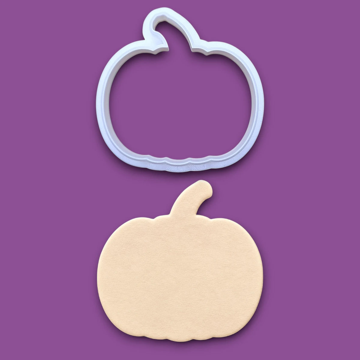 Customizable pumpkin cookie cutter along with a pumpkin dough cutout, perfect for fall, Halloween, and Thanksgiving-themed baking or crafts.