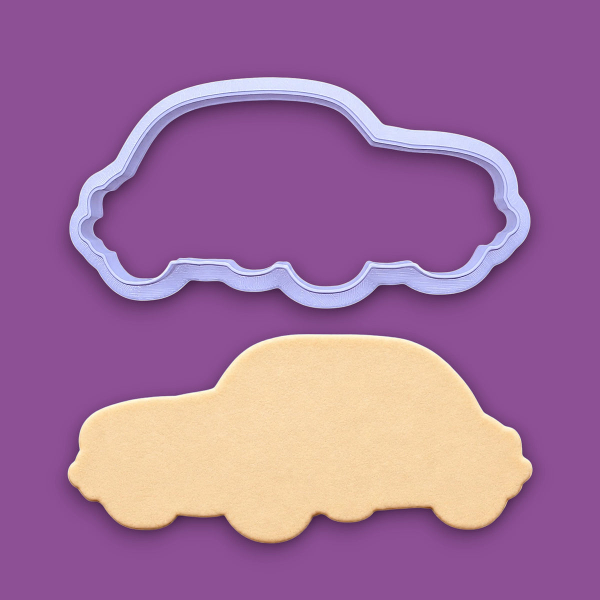 Vintage punch buggy car cookie cutter alongside a dough cutout, perfect for car themed birthdays, ceramics, ornaments and clay projects.