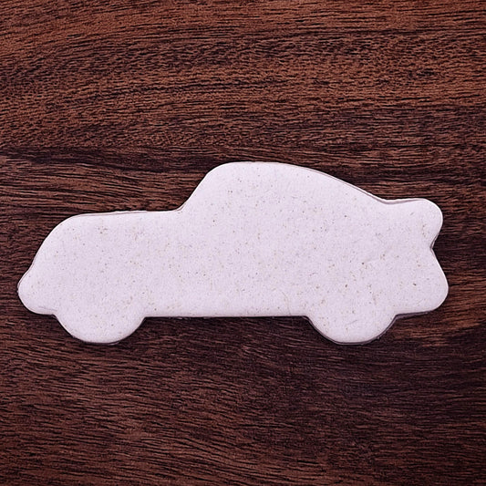 Racecar cookie dough cutout with detailed stamped design. Perfect for racing-themed birthday treats, car cookies, or fun fondant decorations.