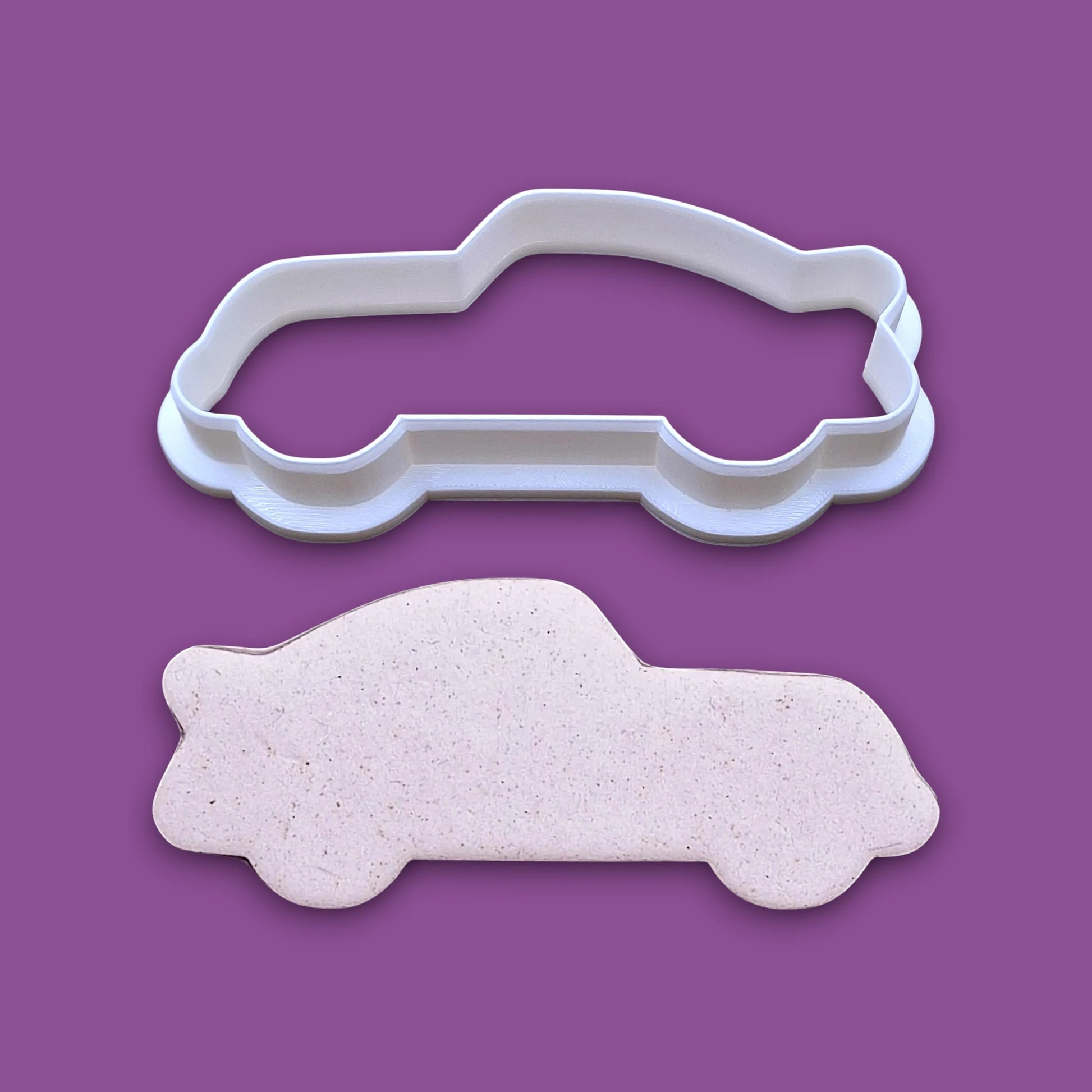 Racecar cookie cutter and dough cutout, perfect for racing-themed birthday treats, car cookies, or fun fondant decorations.