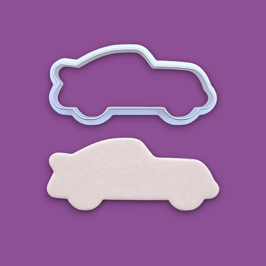 Racecar cookie cutter and dough cutout, perfect for racing-themed birthday treats, car cookies, or fun fondant decorations.