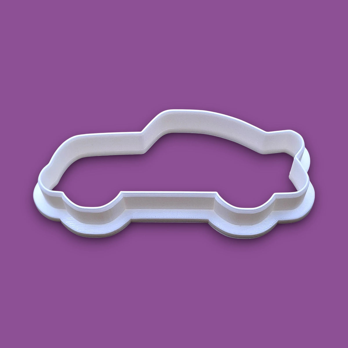 Racecar cookie cutter, ideal for bakers looking for racecar-themed baking tools and cutters.
