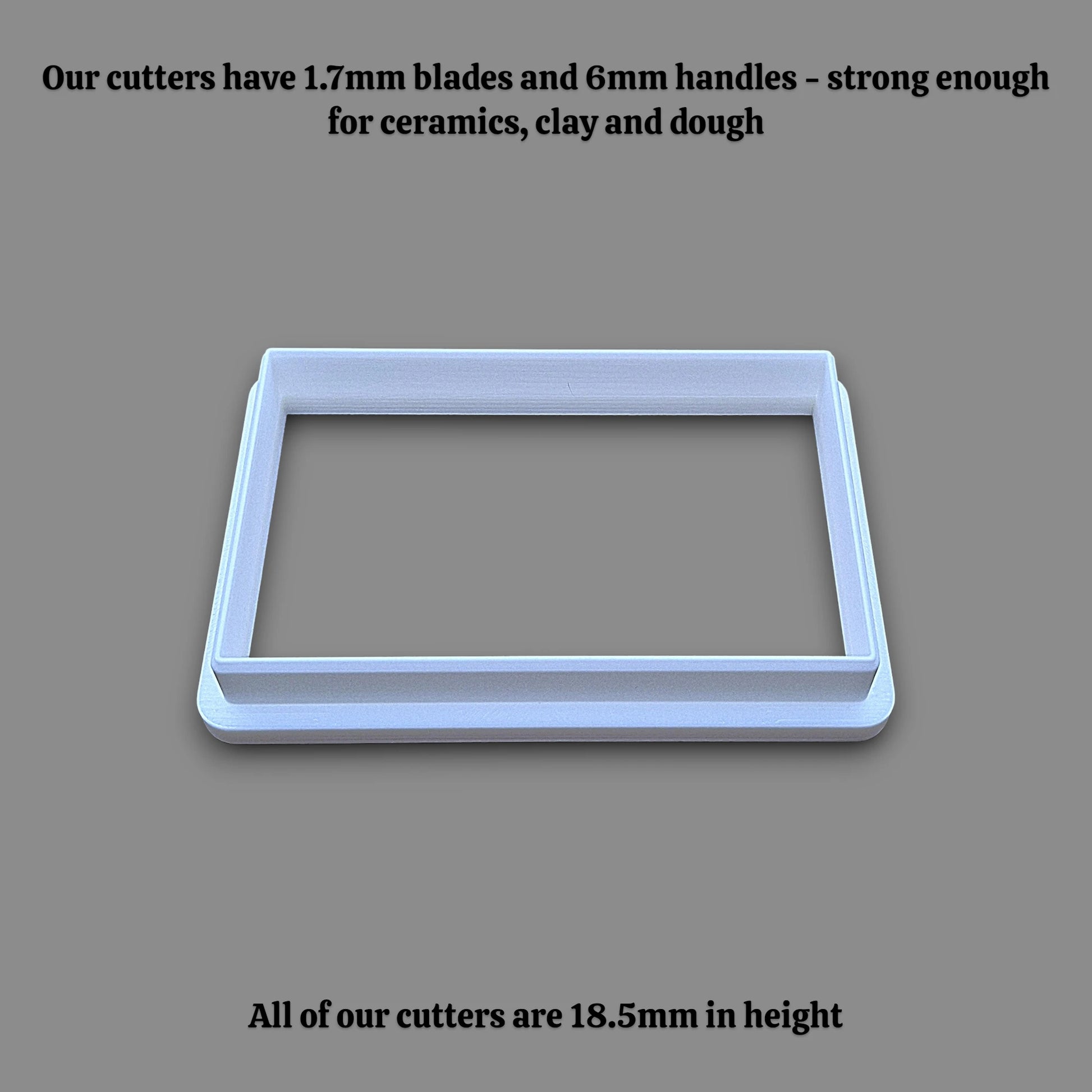 A rectangular cookie cutter shown on a solid gray background, with black text at the top and bottom describing its dimensions and strength.