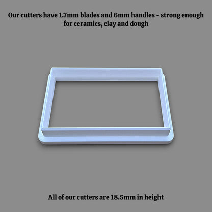 A rectangular cookie cutter shown on a solid gray background, with black text at the top and bottom describing its dimensions and strength.