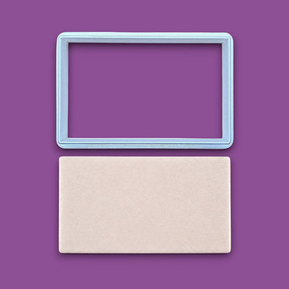 Rectangle cookie cutter alongside a dough cutout, perfect for baking classic shapes, fondant, parties, clay and crafts.