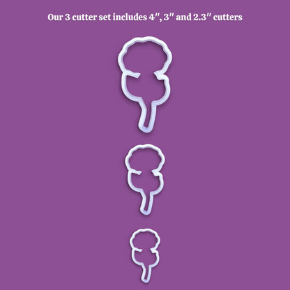 Three white plastic cookie cutters in descending sizes are displayed vertically on a solid purple background, with white text at the top reading 'Our 3 cutter set includes 4", 3", and 2.3" cutters'.