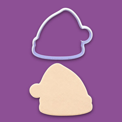 Santa hat cookie cutter and dough cutout, perfect for Christmas cookies, festive fondant toppers, or Xmas holiday crafts.