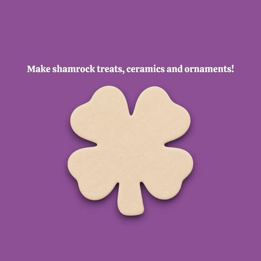A single four-leaf clover-shaped dough cutout make from a shamrock cookie cutter.