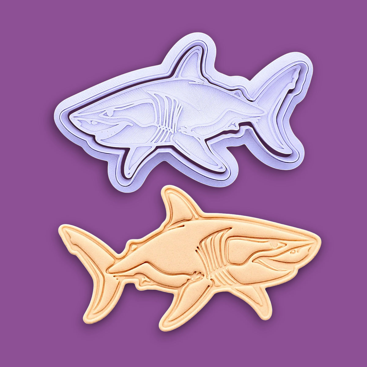 Handmade and customizable shark cookie cutter and stamp alongside a dough cutout and imprint, great for beach themed baking, fondant crafts, or ocean-themed cookies.