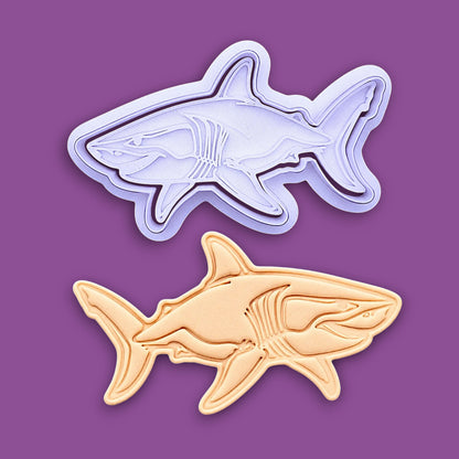 Handmade and customizable shark cookie cutter and stamp alongside a dough cutout and imprint, great for beach themed baking, fondant crafts, or ocean-themed cookies.
