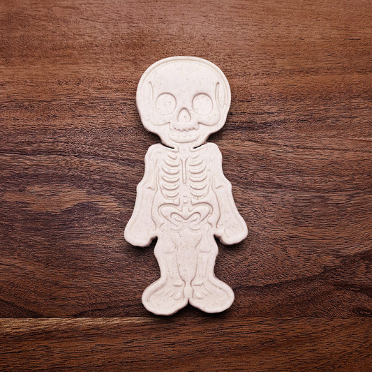 Stamped skeleton cookie dough with bone details. Perfect for Halloween cookies or creepy edible crafts.
