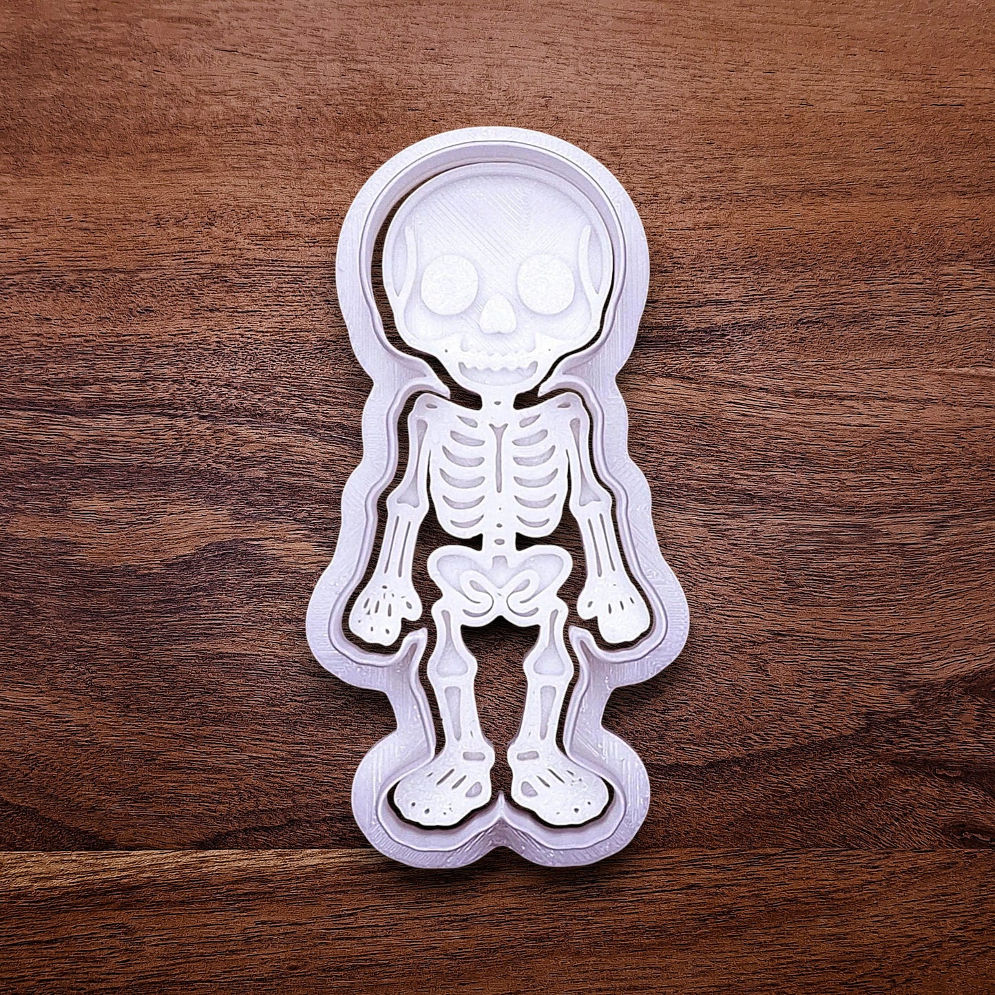 Skeleton cookie cutter with matching stamp that adds bone and skull details—ideal for detailed cookies without decorating.