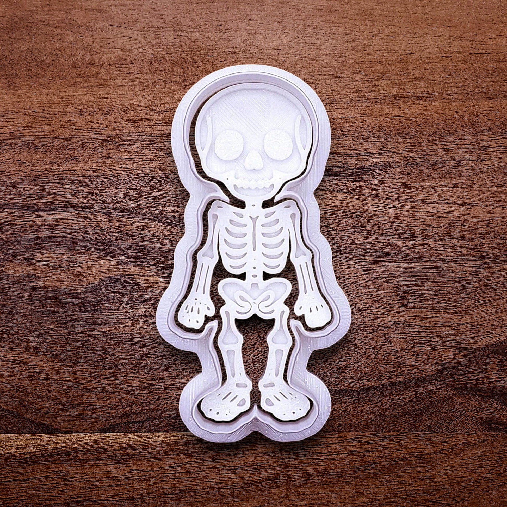 Skeleton cookie cutter with matching stamp that adds bone and skull details—ideal for detailed cookies without decorating.