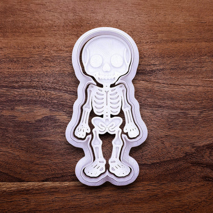 Handmade and customizable skeleton cookie cutter with matching bone stamp. Ideal for centerpiece cookies and spooky decorations.