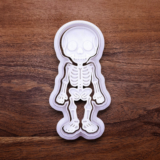 Skeleton cookie cutter with matching stamp that adds bone and skull details—ideal for detailed cookies without decorating.