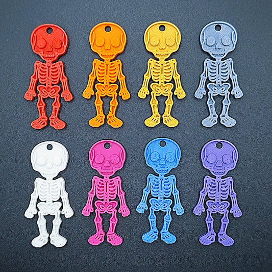 Halloween skeleton keychains in assorted colors—sustainable spooky charms ideal for Halloween gifting, decor, or bone-themed collections.