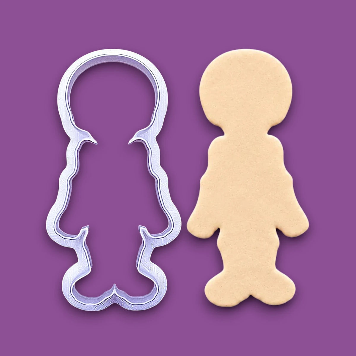 Handmade and customizable skeleton cookie cutter alongside a dough cutout. Ideal for ceramics, fondant, cookies and spooky trick or treats.