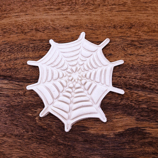 Cookie dough cutout of detailed spiderweb made using the cutter and stamp. Ideal for spooky snacks and Halloween party trays.