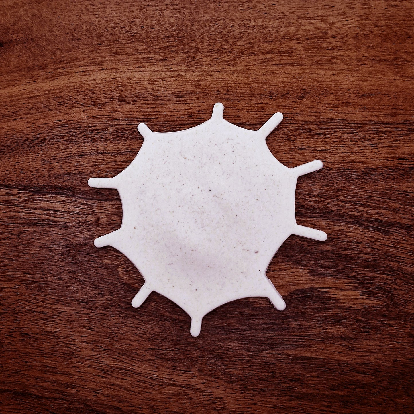 Cookie dough cutout of spiderweb made using the cutter. Ideal for spooky snacks and Halloween party trays.