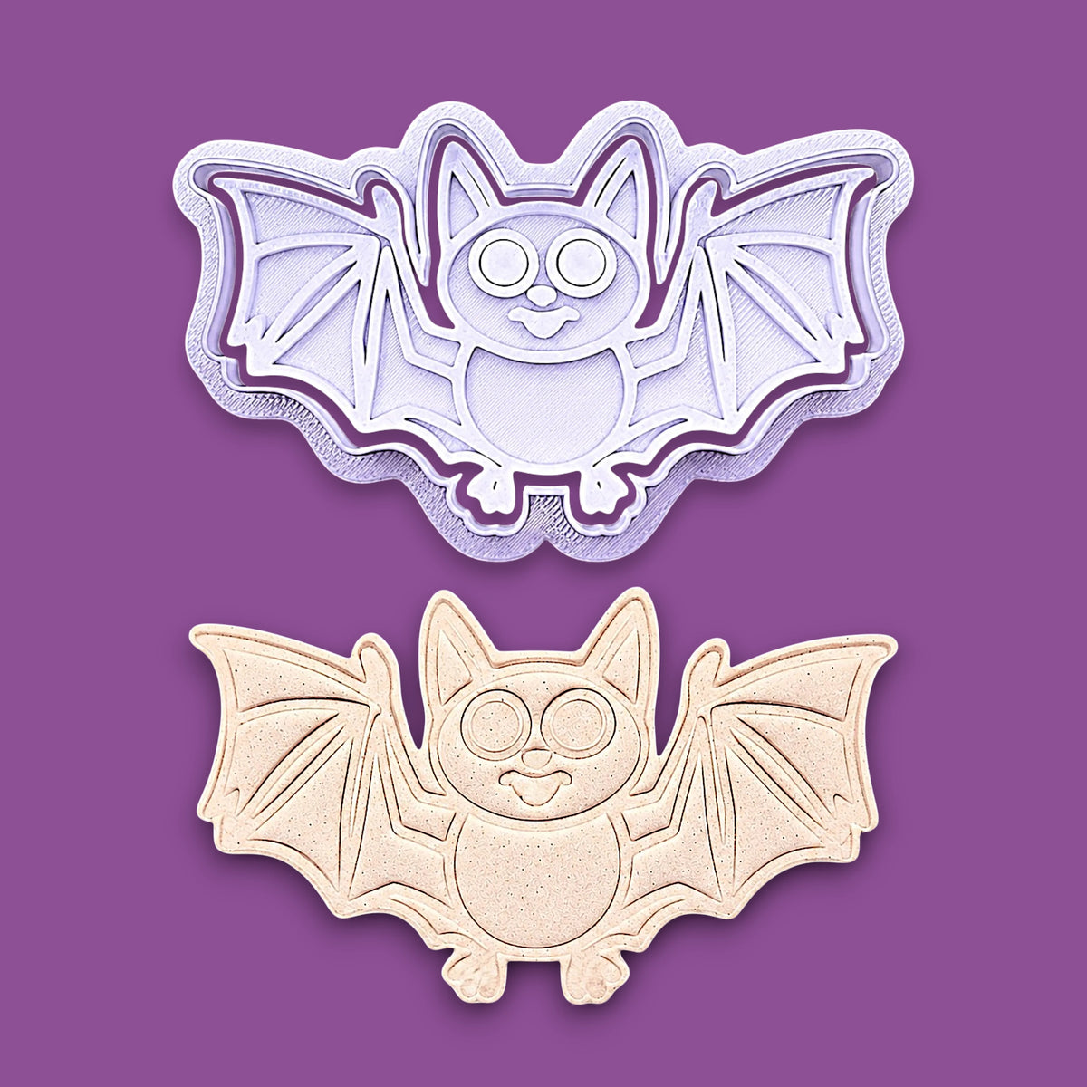 Bat cookie cutter with matching stamps and dough cutout with bat design pressed by cutter and stamp set, showing detailed lines - great for easy Halloween cookie decorating without icing.