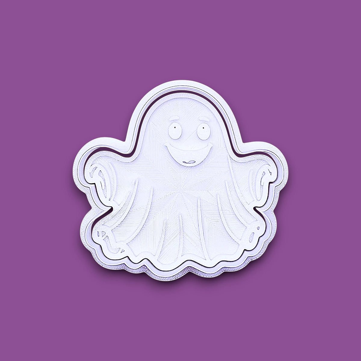 A white ghost-shaped cookie cutter with a smiling face, shown on a solid purple background.