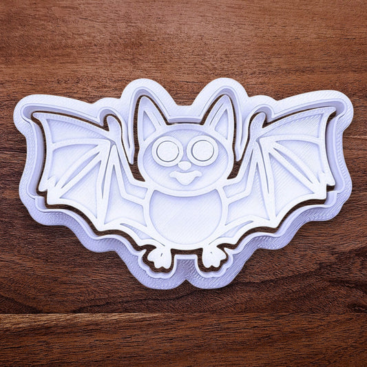 Close-up of bat cookie cutter with matching stamp, perfect for spooky Halloween cookies, fondant crafts, and gothic-themed baking projects.