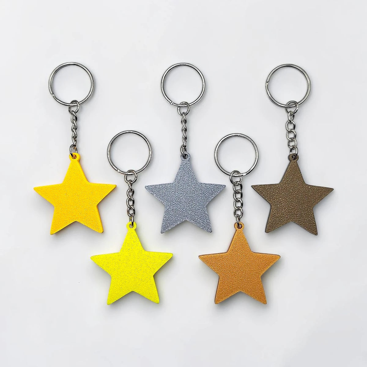 Handmade and customizable star keychains with silver keyrings, made from eco PLA plastic, ideal for classroom prizes, rewards, events, kids, and party favors.