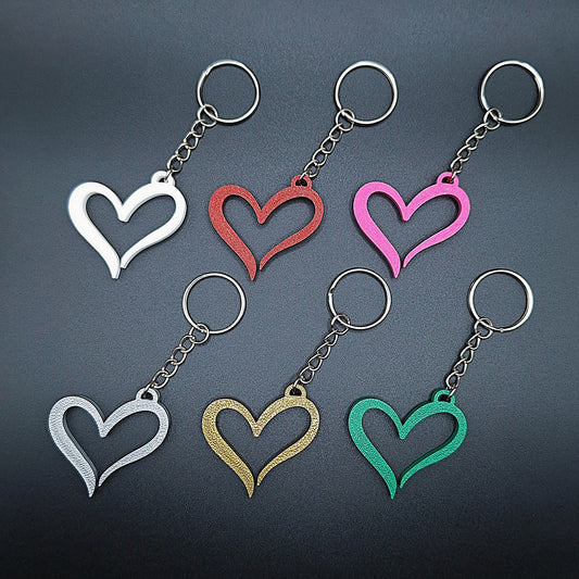 Six minimalist heart keychains in a rainbow of colors, handmade from eco PLA plastic, perfect for Valentine's Day or everyday gift giving.