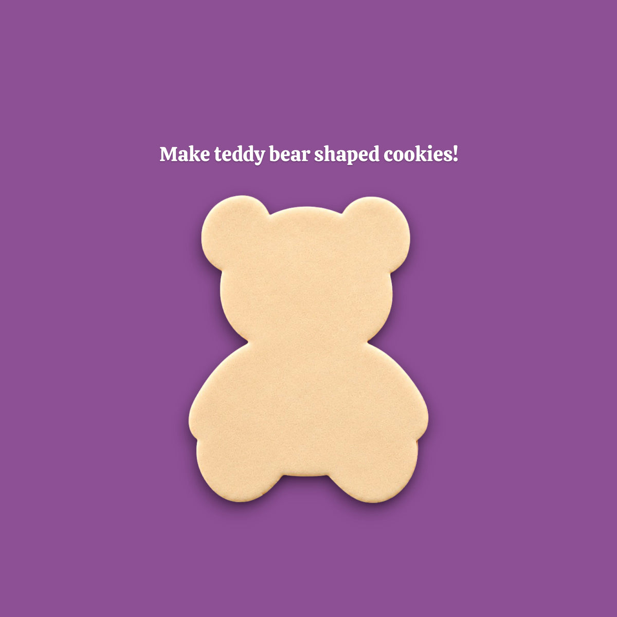 A single teddy bear-shaped cookie centered on a solid purple background, with the text 'Make teddy bear shaped cookies!' above it.