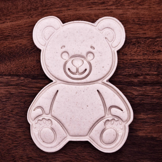 Teddy bear cookie dough imprint made with cutter and stamp. Shows cute face and paw details—perfect for baby showers, birthdays, or kid-friendly bakes.