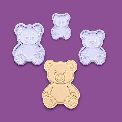 Multiple handmade and customizable teddy bear cookie cutters with stamps featuring a traditional plush bear shape alongside a dough cutout and imprint — perfect for cookies at Valentine's Day parties or baby showers.