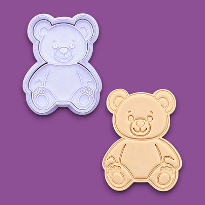 Teddy bear-shaped cookie cutter alongside a dough cutout and imprint shown on a plain gray background. Perfect for baby showers, Valentine's day, and gifting.