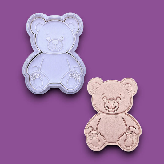 Teddy bear-shaped cookie cutter alongside a dough cutout and imprint shown on a plain gray background. Perfect for baby showers, Valentine's day, and gifting.