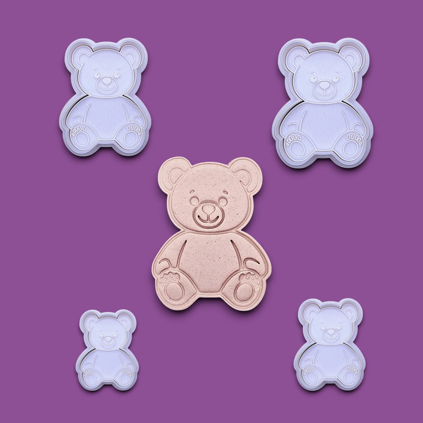 Multiple handmade and customizable teddy bear cookie cutters with stamps featuring a traditional plush bear shape alongside a dough cutout and imprint — perfect for cookies at Valentine's Day parties or baby showers.