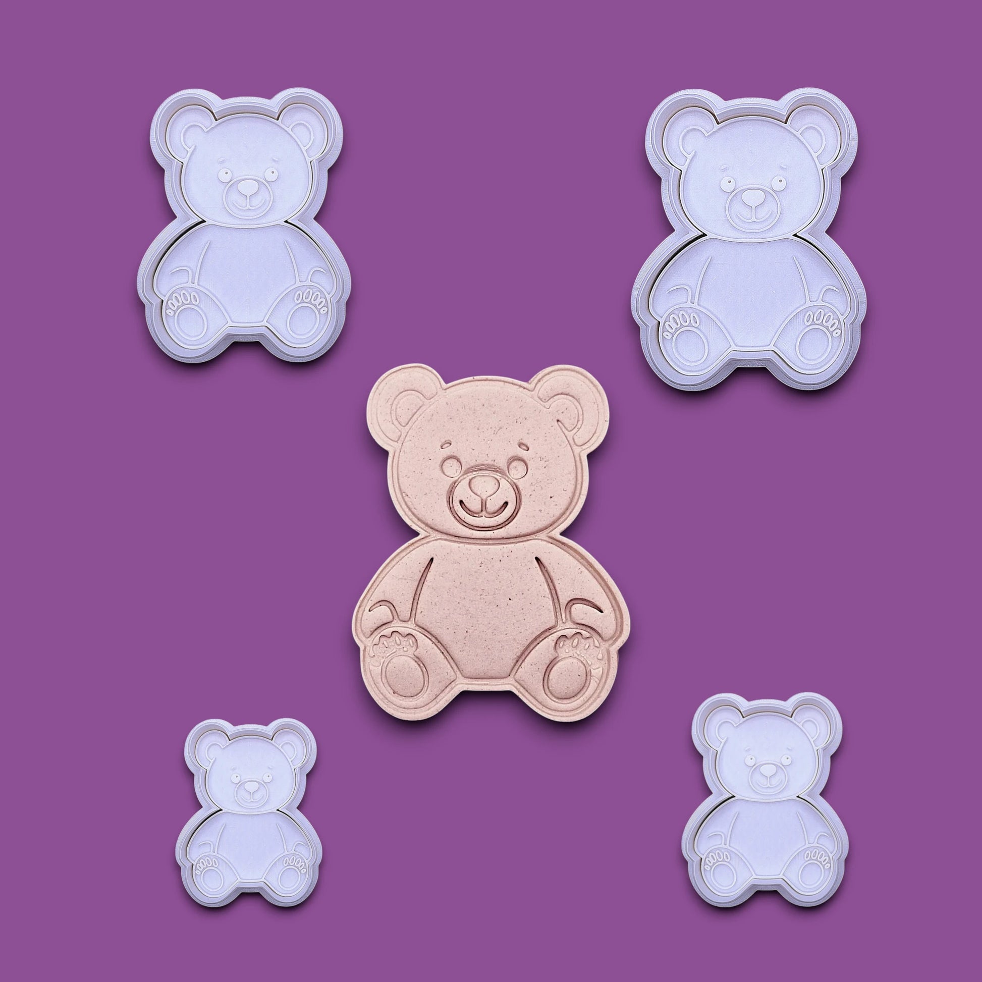 Multiple handmade and customizable teddy bear cookie cutters with stamps featuring a traditional plush bear shape alongside a dough cutout and imprint — perfect for cookies at Valentine's Day parties or baby showers.