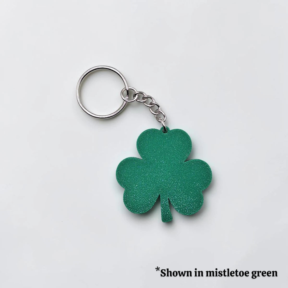 Handmade and customizable shamrock keychain in mistletoe green, perfect for St Patrick's Day party favors and gifts.
