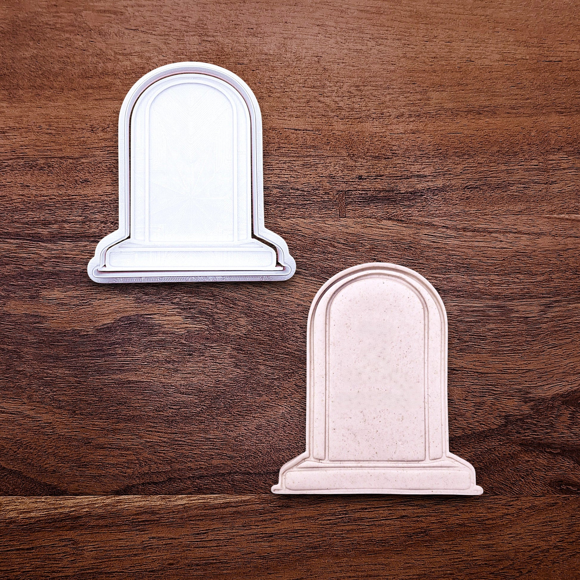 Gravestone cookie cutter with stamp and dough cutout, perfect for Halloween treats and spooky desserts.